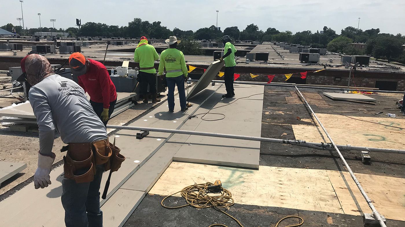 Roofing work on a low-slope building roof