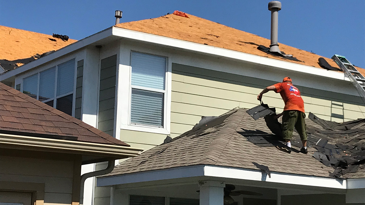 Residential roofing crew working on a home