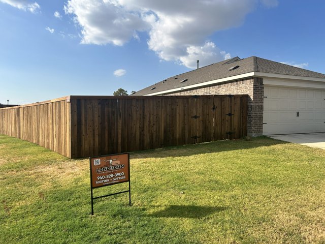 Wood fence along a residential yard.