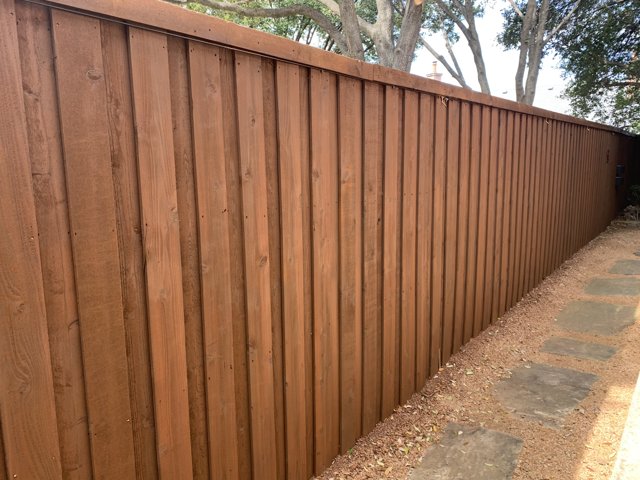 Wood fence with stain finish.