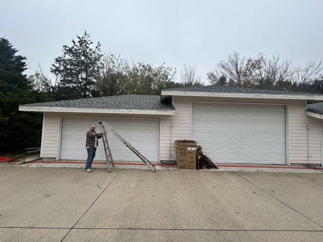 Gutter installation work beside a house.