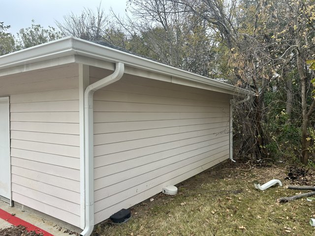 Exterior gutter and downspout on a house.