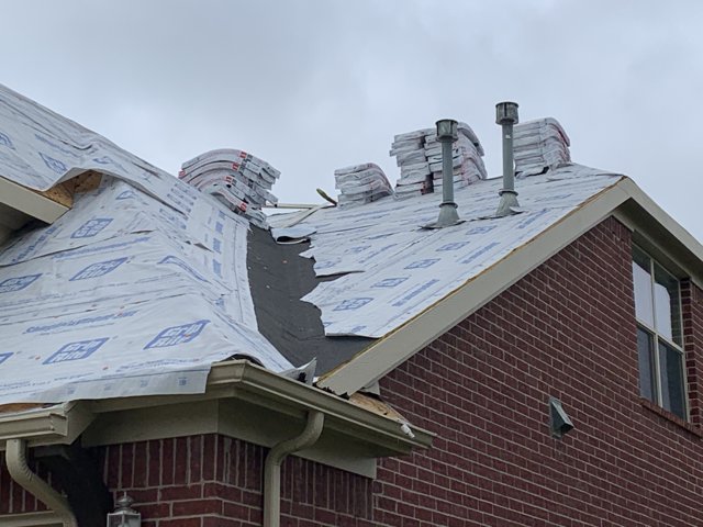 Roof underlayment and vent pipes on a residential roof.