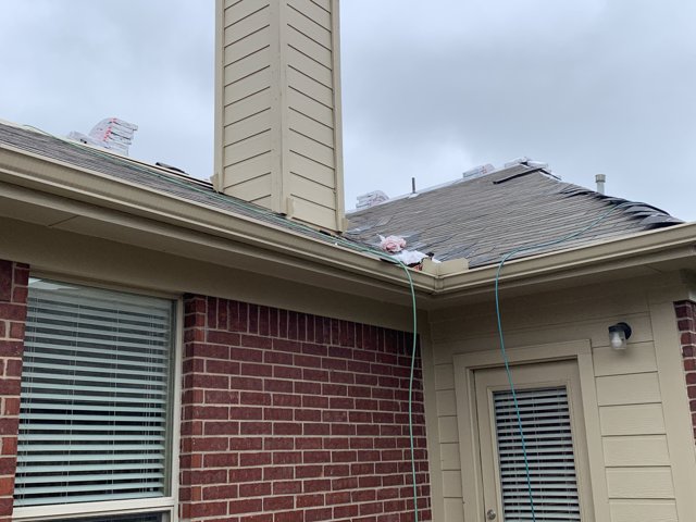 Roof underlayment and chimney on a residential roof.