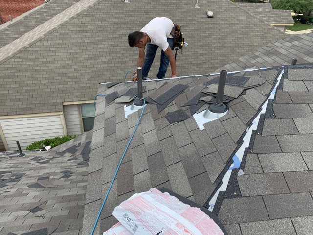 Roofing crew working on a residential roof.